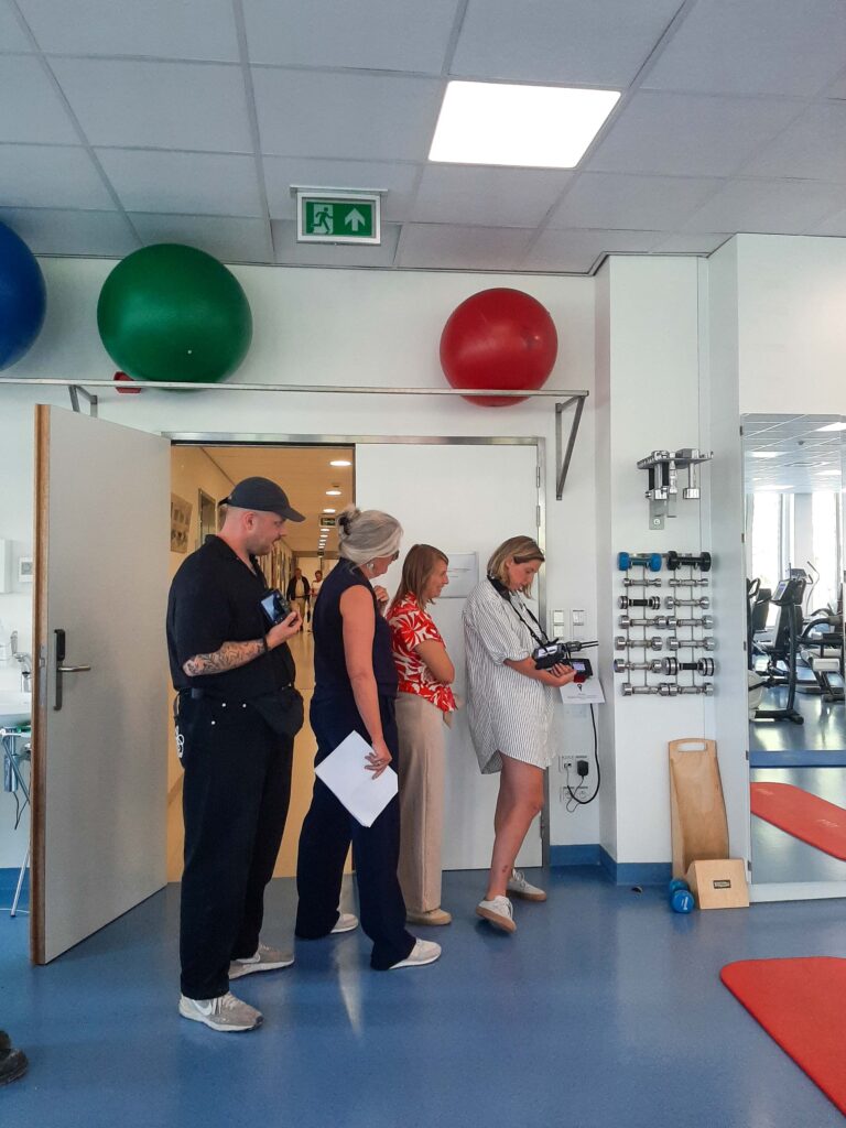 Cameraploeg filmt scène in witte ruimte met medisch bed, behind the scenes EEG